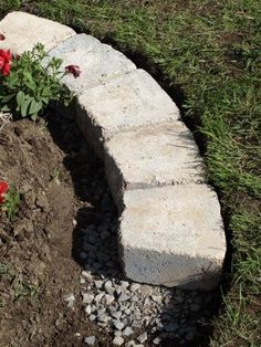 a stone bench with flowers growing out of it