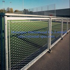 a tennis court is fenced in with chain link fencing on the side of it