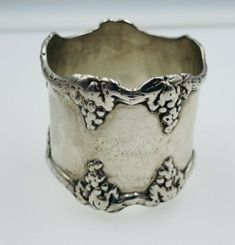 a silver ring with vines on it