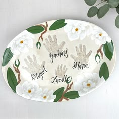 a plate with handprints and flowers on it