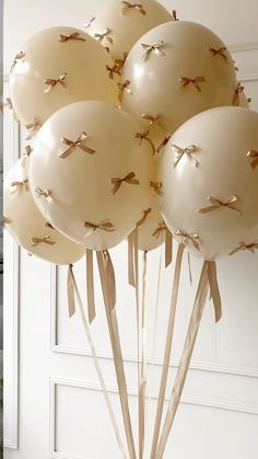 a bunch of balloons that are in the shape of birds on sticks with ribbons attached to them