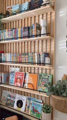 a bookshelf filled with lots of books next to a wall full of books