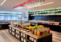 a buffet with lots of food and drinks on it's counter top in a restaurant