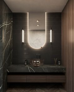 a modern bathroom with marble counter tops and lights on the mirror above the vanity area