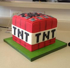 a cake made to look like a cube with the word tht on it