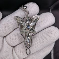 This gorgeous Arwen Evenstar necklace is just like the one she gifted to Aragorn in the Lord of the Rings trilogy. The Arwen pendant is made a high-quality S925 Sterling Silver, which means it will last through the ages. Plus, it comes with a free jewelry box! This Arwen Evenstar pendant is NOT made with cheap materials, like other Evenstar replicas you'll find. Similar Arwen pendants are made with silver toned zinc alloy, plated copper or even aluminum, which will fade over time or easily break Lotr Collection, Arwen Necklace, Lotr Arwen, Lord Of The Rings Jewelry Elves, Eowyn Necklace, Lord Of The Rings Necklace, Evenstar Necklace, Arwen Evenstar Necklace, Handmade Silver Elvish Necklace