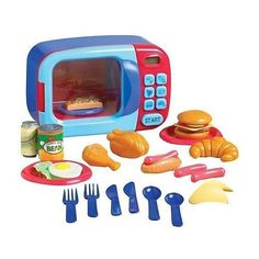 there is a toy microwave with food and utensils