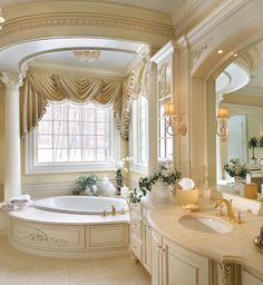 a large bathroom with an oval tub and chandelier