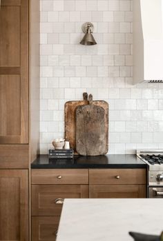 a wooden cutting board sitting on top of a kitchen counter