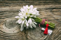 a bouquet of white flowers sitting on top of a wooden table next to a candy cane