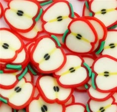 red and white sliced apples with green stems