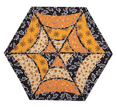 an orange, black and white umbrella with designs on the bottom half is shown in this image