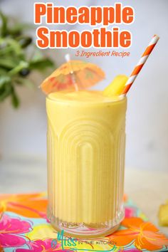 a pineapple smoothie in a glass with an orange umbrella