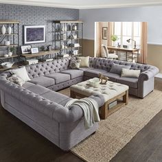 a living room filled with lots of furniture and decor on top of a hard wood floor