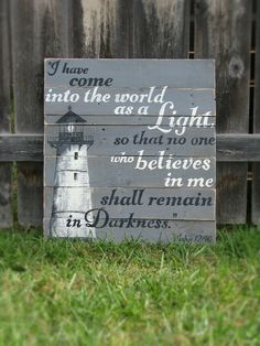 a wooden sign that says i have come into the world as light