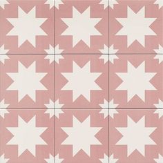 a pink and white tile with stars on it