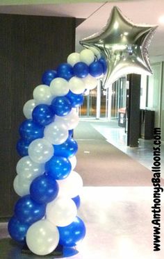 blue, white and silver balloon arch in an office lobby