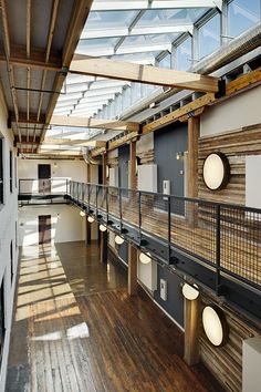 an empty building with wooden floors and metal railings