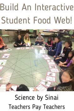 a group of children sitting on the floor in front of a circular table with food