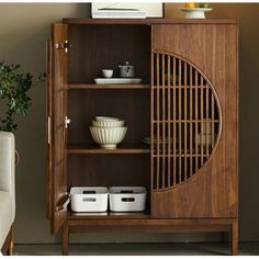 a wooden cabinet with baskets and bowls in it