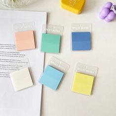 several sticky notes are placed on top of a piece of paper