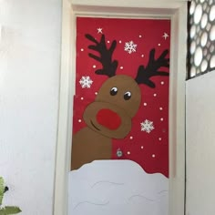 a door decorated to look like a reindeer with snowflakes on its nose and nose