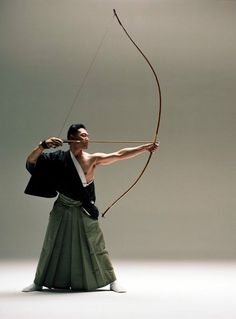 a man with a bow and arrow in his hand