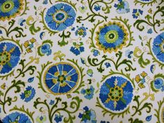 a blue and green floral design on white fabric