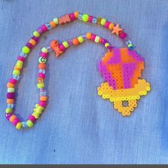 a colorful beaded necklace with a cross on it