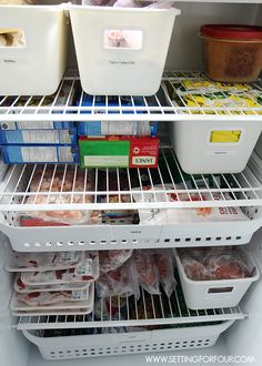 an open refrigerator filled with lots of food and plastic containers on the bottom shelf,