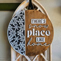 there's snow place like home sign hanging from the side of a door frame