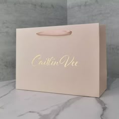 a pink paper bag with the word'cattin vee'written on it