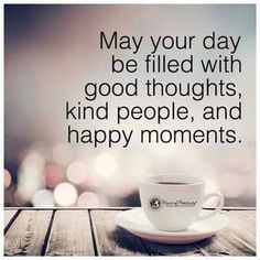 a coffee cup sitting on top of a wooden table next to a quote that reads, may your day be filled with good thoughts