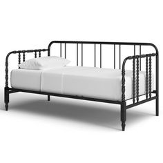 a black metal bed frame with white sheets and pillows on the bottom, in front of a white background