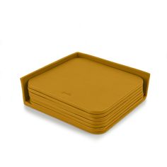 a stack of yellow plates sitting on top of each other in front of a white background