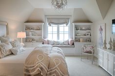 a bedroom with a large bed and white furniture