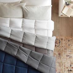 four different colored pillows stacked on top of each other