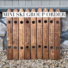 a wooden fence with holes in it and the words, mini ski group order