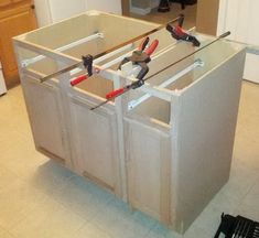 an unfinished kitchen cabinet with tools in it