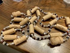 a bunch of wine corks that are sitting on a table with some beads around them