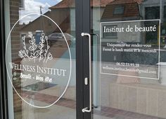 a glass door with the words, institution de beaute on it's side