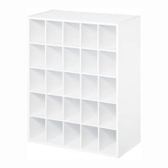 a white shelving unit with many compartments