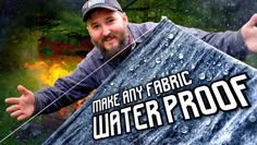 a man holding up a sign that says make any fabric water proof