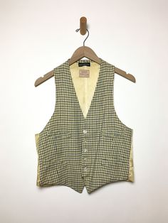 Just so good. Old wool vest with label intact. Gender neutral. As found, aged to perfection. Fabric: WoolLabel: Tattersall for Raleigh HaberdasherFit: M Measurements (flat): Armpit to armpit 19.5 inches Shoulder (across) 10.5 inches Arm opening 11.5 inches Length (back) 20.5 inches Waist 18.5 inches Condition: Good. Several small holes, some stains. Fitted Wool Vest Top, Classic Sleeveless Vest For Daywear, Classic Plaid Vest For Fall, Classic Wool Vest For Spring, Classic Spring Wool Vest, Classic Plaid Vest, Classic Plaid Sleeveless Vest, Vintage Sweater Vest For Fall Workwear, Tailored Cotton Vest For Fall