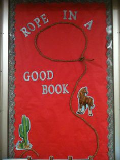 rope in a good book bulletin board with cactus and horse on red background, surrounded by silver trim