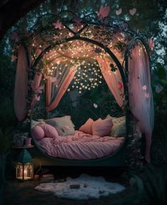 a bed with pink sheets and pillows under a canopy covered in fairy lights at night