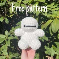 a hand holding a crocheted white stuffed animal with the words free pattern above it