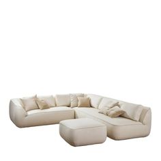 a large white sectional couch with pillows on it