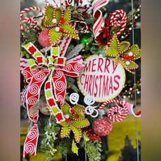 a christmas wreath with candy canes and decorations