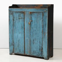 an old blue cabinet with two doors